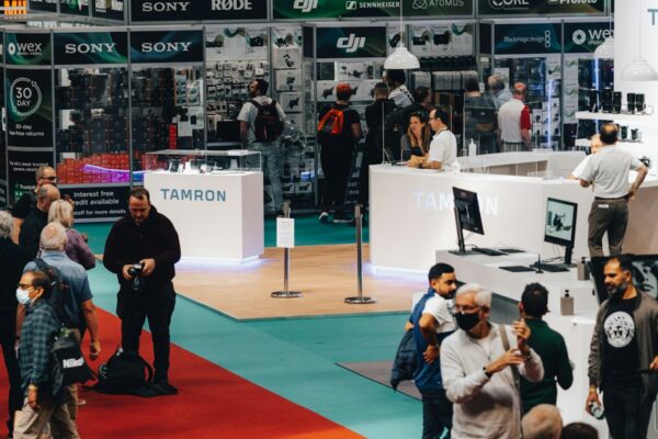 a group of people standing around a booth