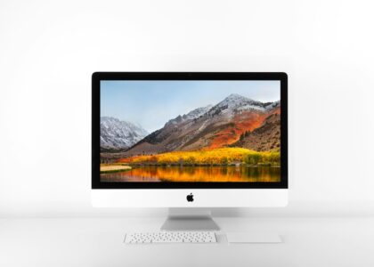 silver iMac and Magic keyboard on white surface
